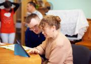 Social worker working with a class of people with learning difficulties